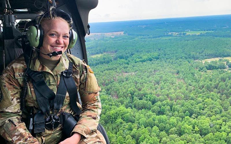 Woman riding in helicopter.